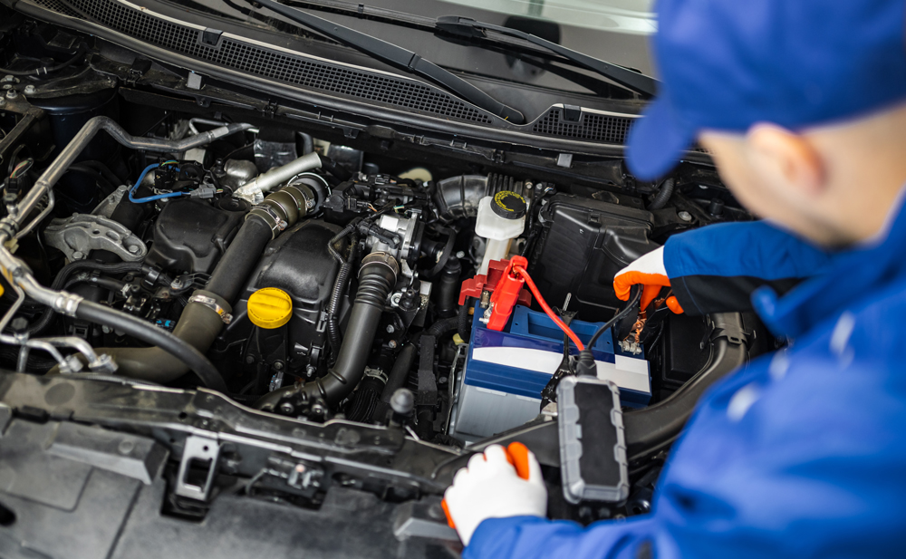 Man jump starting a cars battery
